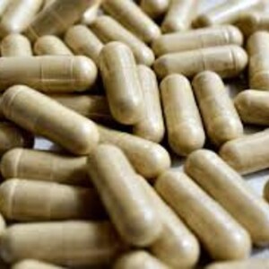 May include: A large pile of beige capsules, likely a dietary supplement or herbal remedy.