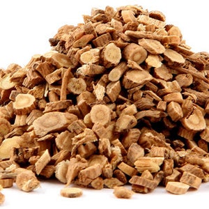 May include: A pile of dried, light brown, irregularly shaped pieces of angelica root.