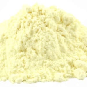 May include: A close-up of a pile of yellow cornmeal powder.
