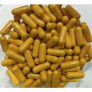 May include: A large quantity of yellow capsules in a bowl. The capsules are a dietary supplement.