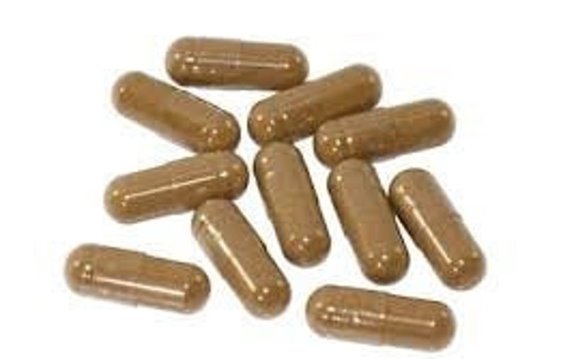 May include: A group of ten brown capsules, likely a dietary supplement or herbal remedy.
