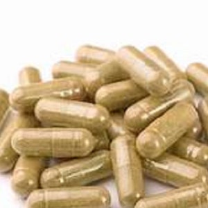 May include: A pile of tan and brown capsules, likely herbal supplements.