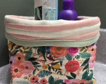 Quilted storage basket with pink lining