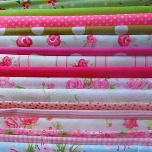 May include: A collection of folded fabrics in pink, green, and white. The fabrics feature floral, polka dot, and striped patterns. The image displays a range of textures and designs, with the fabrics neatly stacked and organised.