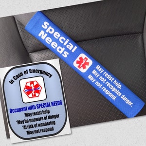 May include: A blue seatbelt cover with the words "Special Needs" and a medical alert symbol. The cover also includes the phrases "May resist help," "May not recognize danger," and "May not respond." A sticker reads "In Case of Emergency" and "Occupant with SPECIAL NEEDS."