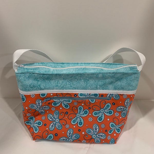LIP2025- Lunch Bag: "Butter Flying" washable insulated lunch bag with zippered front pocket and zippered top closure.