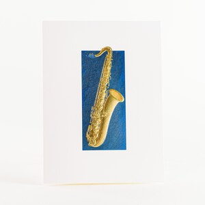 Carte pour saxophone. Carte en feuille d'or. Carte de musique en relief. Paquet de 6 cartes ou une carte. Saxophone doré dans un cadre bleu.