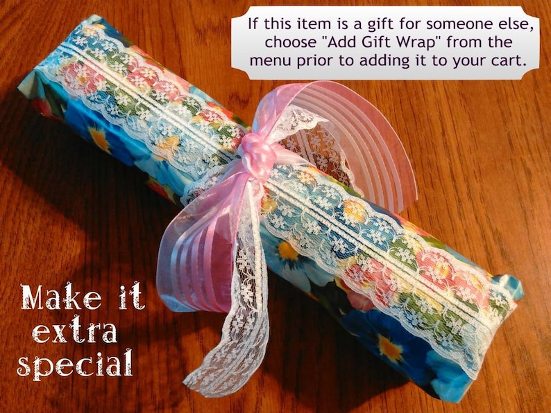 May include: A gift wrapped in blue and white floral paper with pink and white lace ribbon. The gift is tied with a pink ribbon and has a white lace trim. The text "Make it extra special" is written in white on a brown background.