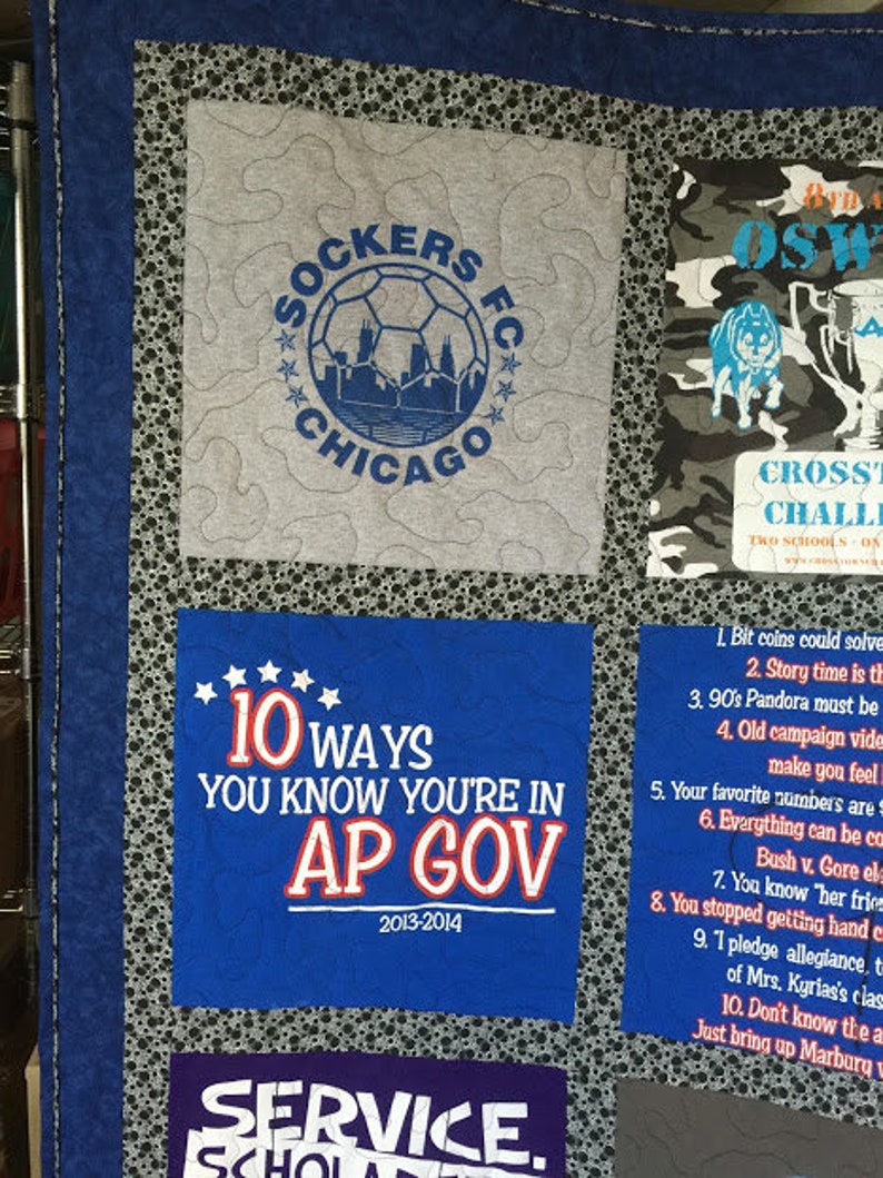 May include: A blue and white quilt with various patches. One patch features a soccer ball with the text "Sockers FC Chicago" and another patch features the text "10 Ways You Know You're in AP Gov 2013-2014".