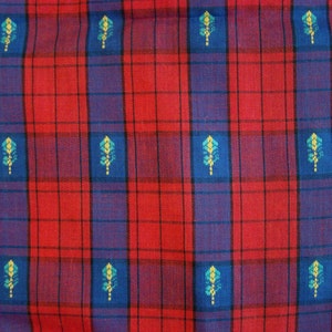 May include: Red and blue plaid fabric with a repeating pattern of small blue and yellow stylized leaves.