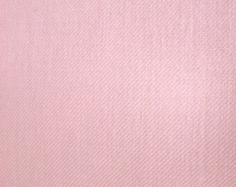 May include: A solid light pink fabric featuring a distinct diagonal twill weave pattern. The textile surface displays a consistent, uniform color and a tight, structured weave texture that runs consistently across the entire visible area of the material.