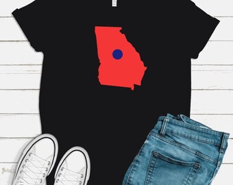 May include: Black t-shirt with a red outline of the state of Georgia and a blue circle in the center.