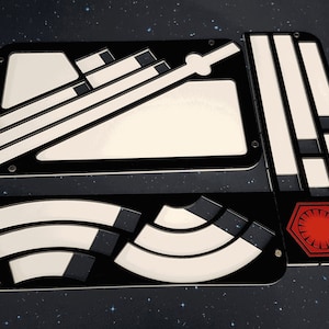 May include: A set of four black and white laser-cut acrylic panels with a Star Wars theme. The panels feature the First Order symbol, a TIE fighter, and other geometric shapes.