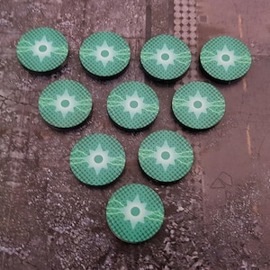May include: Ten green and white circular tokens with a starburst design and lightning bolts. The tokens are arranged in a heart shape.