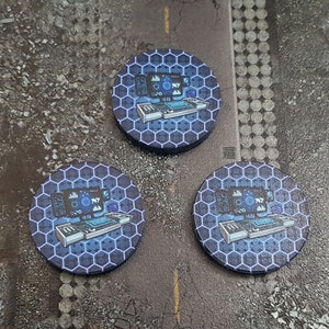 May include: Three round blue and black gaming tokens with a hexagonal pattern and a computer monitor and keyboard design.