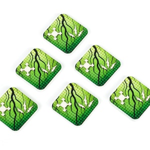 May include: Six green and black square-shaped game tokens with a white directional arrow symbol in the center. Each token has a black lightning bolt design and a green and black wavy line design.
