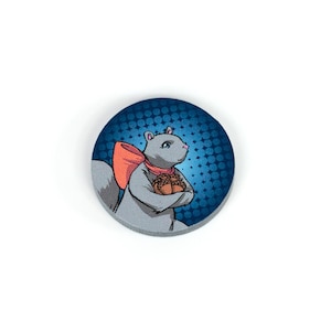 May include: A gray squirrel with a pink nose and a red bow is holding a pile of acorns. The squirrel is on a blue background with white polka dots.