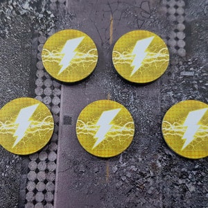 May include: Five yellow round tokens with a white lightning bolt design. The tokens have a textured surface and a yellow border.