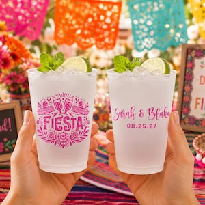 May include: Two frosted plastic cups filled with ice, lime wedges, and mint leaves. One cup features a pink graphic with the text FIESTA, tacos, and champagne flutes. The other cup displays the pink text Sarah & Blake and the date 08.25.27.