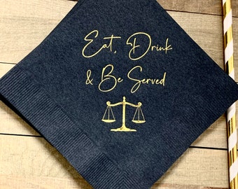 May include: Black paper napkin with gold foil lettering that reads "Eat, Drink & Be Served" and a gold scale of justice graphic.