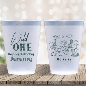 May include: Two white plastic cups with a light blue rim. One cup has the text "Wild ONE Happy Birthday Jeremy" in dark green. The other cup has a jungle animal illustration and the date 06.25.25.