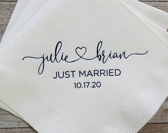 May include: White paper napkins with black text that reads "julie ♥ brian JUST MARRIED 10.17.20".