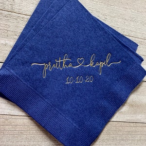 May include: Navy blue paper napkins with gold lettering. The text reads "priutha &hearts; kapil" and "10.10.20".
