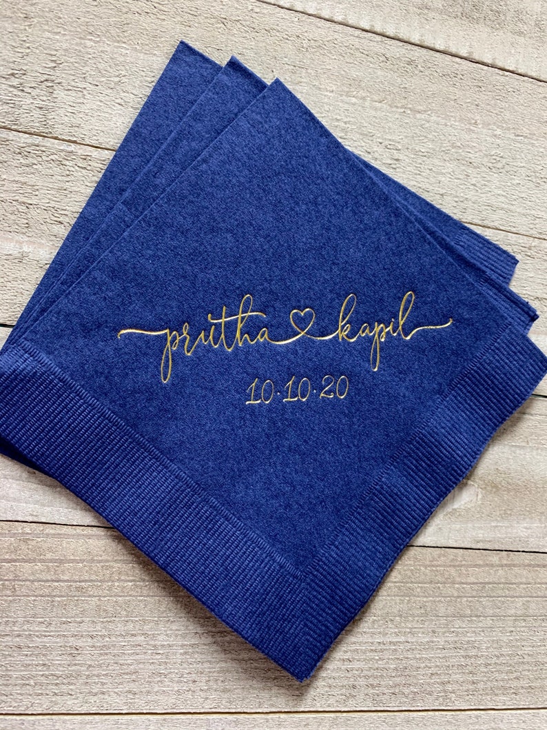 May include: Navy blue paper napkins with gold lettering. The text reads "priutha &hearts; kapil" and "10.10.20".