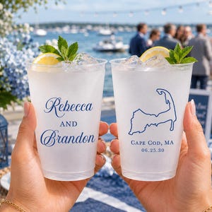 May include: Two frosted plastic cups filled with ice, lemon slices, and mint leaves. One cup features the blue text "Rebecca AND Brandon," while the other displays a blue outline of Cape Cod, Massachusetts, with the text "CAPE COD, MA 06.25.30."
