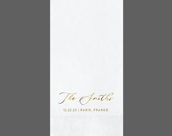 May include: White paper napkin with gold foil lettering. The text reads "The Smiths 12.22.23 | Paris, France".