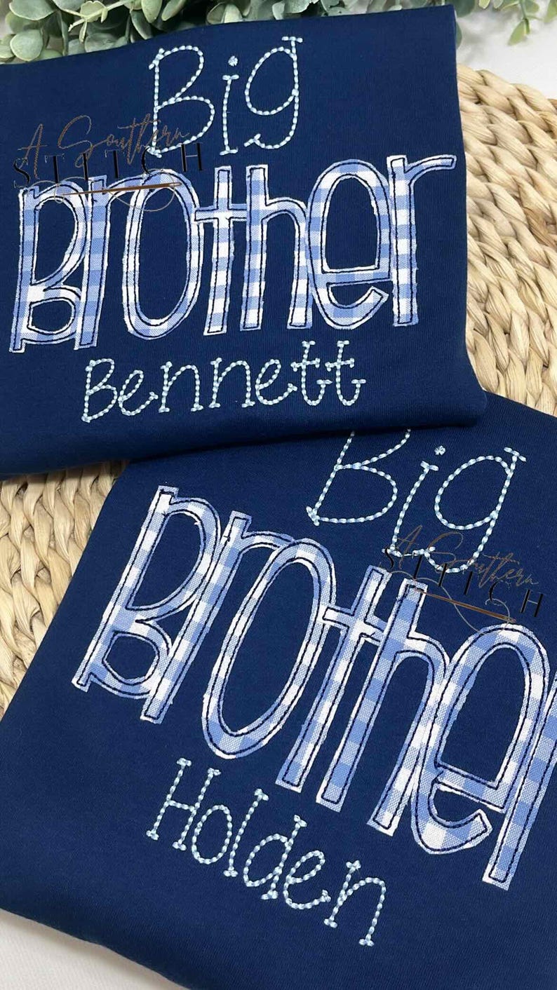 May include: Two navy blue shirts with white and blue gingham patterned text that reads "Big Brother" with a name underneath. The top shirt says "Bennett" and the bottom shirt says "Holden".