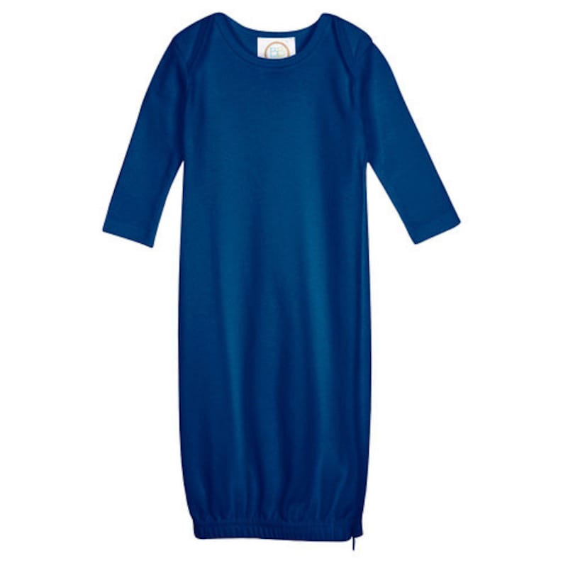 May include: A royal blue long-sleeved gown for a baby. The gown has a round neckline and a gathered bottom.