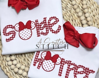 May include: Two white shirts with red gingham and red Minnie Mouse heads embroidered on them. The shirts say "Sigie" and "Horner".