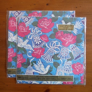 May include: Two sheets of blue and white gift wrap with a floral pattern of pink roses and white doves. The text on the wrapping paper reads "Just a Craft Shower Wedding/Marriage".