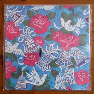 May include: Blue wrapping paper with a repeating pattern of white doves, pink roses, and blue bells with white ribbons.