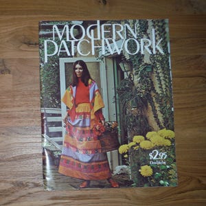 May include: The cover of a book titled "Modern Patchwork" features a woman in a patchwork outfit. The woman is standing in front of a door with a basket of flowers. The cover has a vintage aesthetic with a price tag in the bottom right corner.