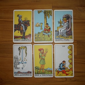 May include: Six tarot cards arranged in two rows of three. The top row features the Knight of Pentacles, Four of Cups, and Queen of Cups. The bottom row displays the Ace of Swords, Page of Pentacles, and Eight of Pentacles, each with colorful illustrations.