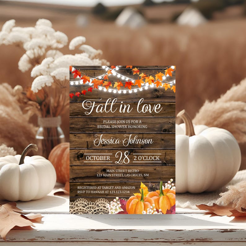 May include: A rustic invitation with the text "Fall in love" for a bridal shower. The design features a wooden background, string lights, autumn leaves, and pumpkins. The invitation includes the date, time, and location.