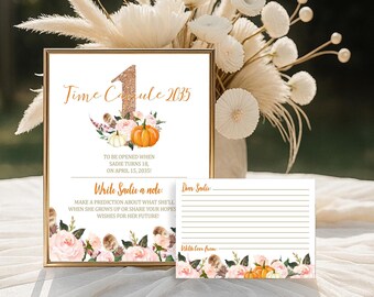 Op de afbeelding: Een ingelijst bord en een kaart met bloemen- en pompoenversieringen. Op het bord staat "Time Capsule 2035" met tekst eronder, waaronder "Write Sadie a note". De kaart is om een notitie aan Sadie te schrijven. Het thema is een verjaardagsfeest.