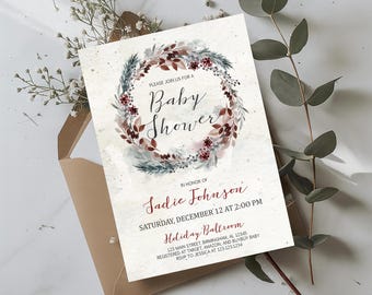 Peut inclure: Invitation de baby shower avec une couronne de fleurs aquarelle bordeaux, verte et blanche. L'invitation comprend le texte "Please join us for a Baby Shower" et les détails de la baby shower de Sadie Johnson.