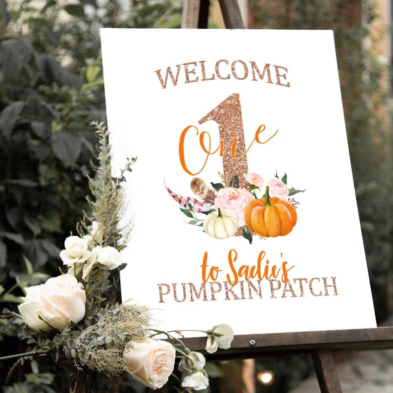 May include: A white sign with the words "WELCOME One" in glittery copper lettering, with a floral and pumpkin design. The sign reads "to Sadie's PUMPKIN PATCH" in copper lettering. The sign is displayed on a wooden easel.