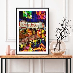 May include: A framed photograph of a colorful street scene with hanging lanterns and signs. The signs are in Portuguese and read "CIÊNCIA DE DEU" and "NOSTRA IRMÃ".