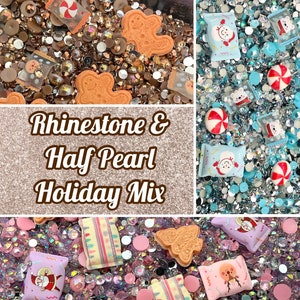 May include: A mix of holiday-themed rhinestones and half pearls in a variety of colours, including gold, silver, blue, pink, and white. The mix includes gingerbread men, candy canes, and gift bags.
