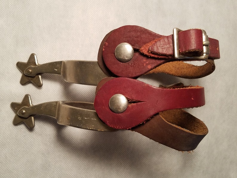 Pair of Marked North and Judd Spurs with 5 Point Star Rowels with Straps