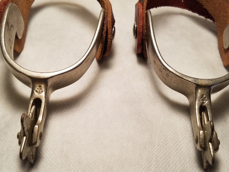 Pair of Marked North and Judd Spurs with 5 Point Star Rowels with Straps