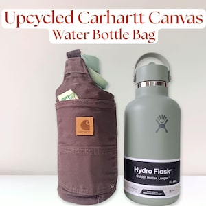 Back pocket view of brown Carhartt 12 oz canvas pants, upcycled into a water bottle carrier bag. The crossbody sling has the original leather logo on the back pocket. There is a 64 oz Hydro Flask bottle inside of the carrier.