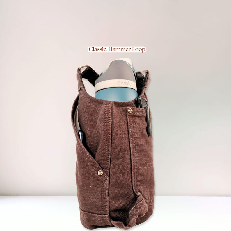 Side view of brown canvas bottle holder showing deep main compartment securely holding a large water bottle.