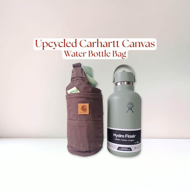 Back pocket view of brown Carhartt 12 oz canvas pants, upcycled into a water bottle carrier bag. The crossbody sling has the original leather logo on the back pocket. There is a 64 oz Hydro Flask bottle inside of the carrier.