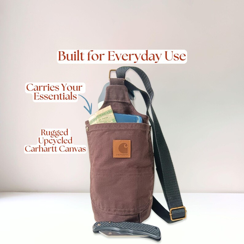 Carhartt-style canvas water bottle holder shown holding a tumbler, cell phone, and money, all inside of the bag. Designed for everyday use with rugged construction.