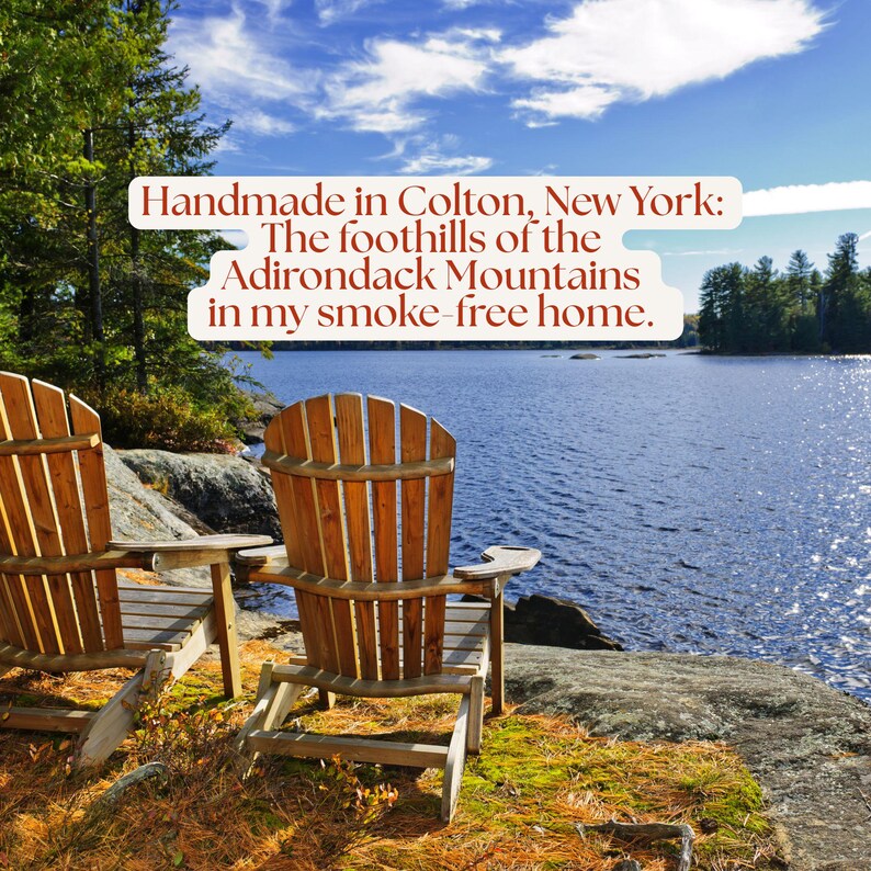 Two wooden Adirondack chairs overlooking a lake surrounded by autumn trees. All items are crafted in Colton, New York, in the foothills of the Adirondack Mountains in a smoke-free home.